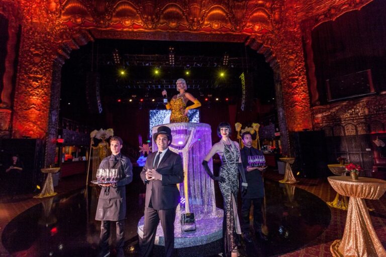 Five costumed performers in a Holiday Inn themed production on stage with coordinated vintage costumes, photographed in Los Angeles.